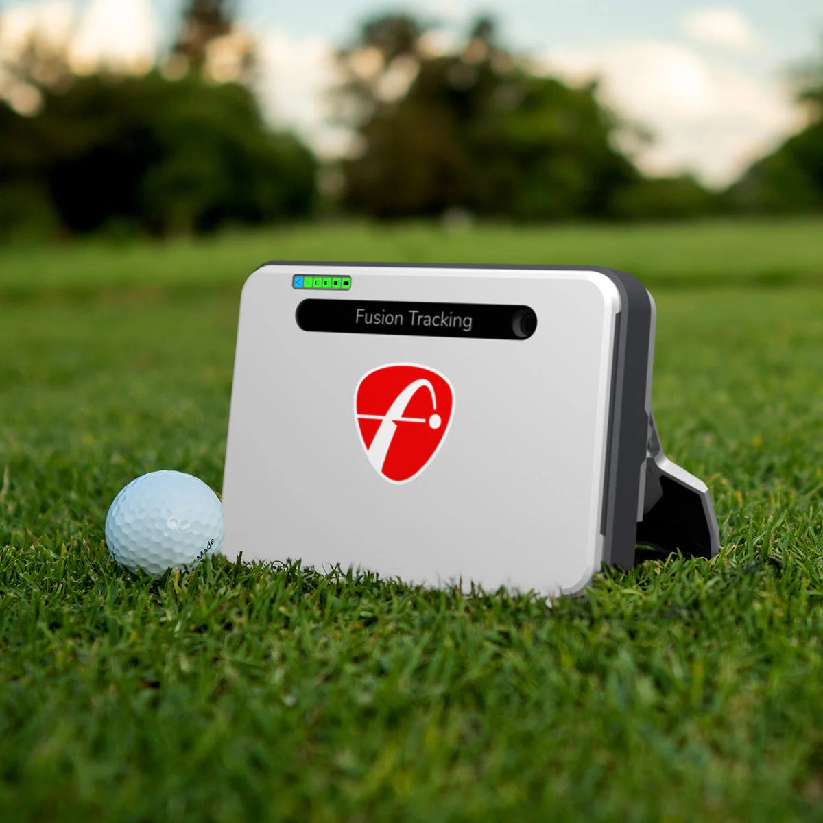 flightscope mevo plus launch monitor in grass with golf ball