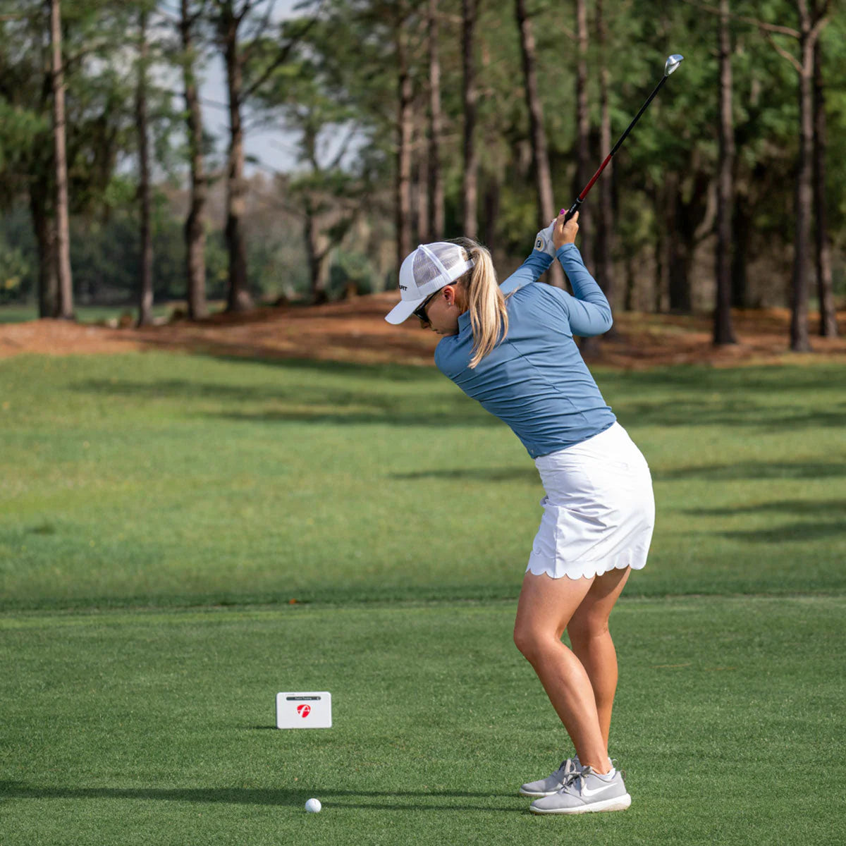 flightscope mevo plus launch monitor with a golfer 